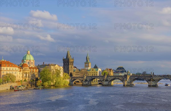 Charles Bridge (Karluv Most) on Vltava river and Old Town Bridge Tower, famous tourist destination in Prague, Czech Republic (Czechia), at sunset