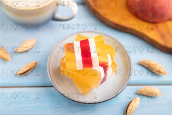 Almond milk and peach jelly on blue wooden background. side view, close up, selective focus