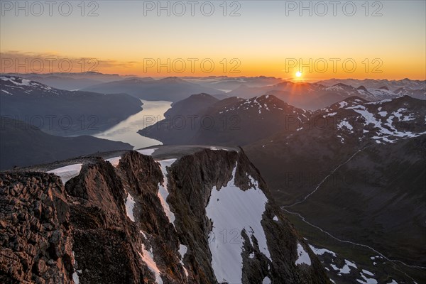 View of mountains and fjord Faleidfjorden, sun star at sunset, summit of Skala, Loen, Norway, Europe