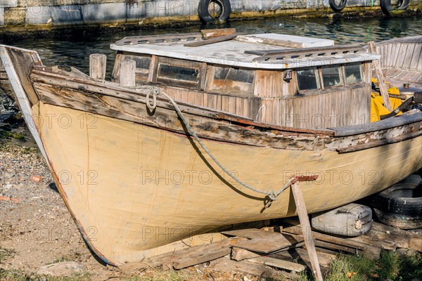 Derelict wood boat in dry dock at harbor in Istanbul in Istanbul, Tuerkiye