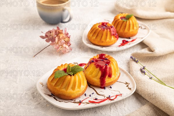 Semolina cheesecake with strawberry jam, lavender, cup of coffee on gray concrete background and linen textile. side view, close up