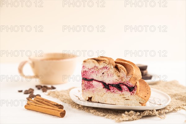 Zephyr or marshmallow cake with cup of coffee on white wooden background and linen textile. side view, close up, selective focus