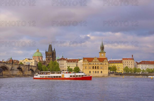 View of old town with Charles Bridge (Karluv Most) on Vltava river and Old Town Bridge Tower, famous tourist destination in Prague, Czech Republic (Czechia), at sunset