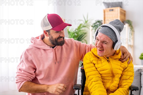 Smiling disabled man and caregiver during art therapy session with music at home