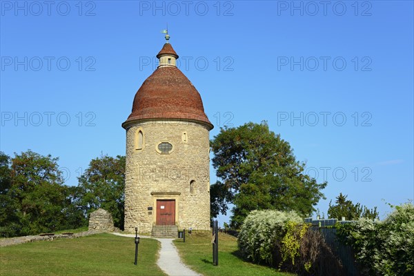 An old round tower with a red roof under a clear blue sky surrounded by green foliage, Rotunda of St.Juraj, Skalica, Skalitz, Trnavsky kraj, Slovakia, Europe