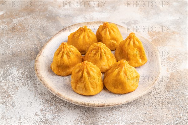 Fried manti dumplings on gray concrete background. Side view, close up