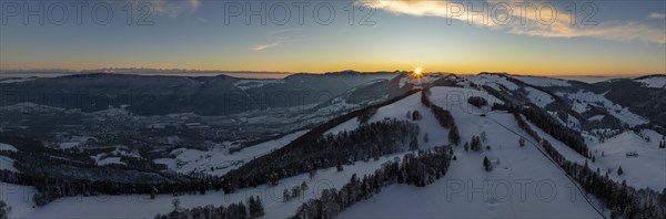 Sunset over the second Jura chain in winter, foreground contours of sinkholes, view towards the first Jura chain with Weissenstein, drone image, Brunnersberg, Solothurn, Switzerland, Europe