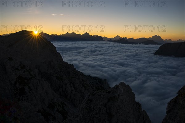 Sunrise over a sea of fog and Dolomite peaks in the background, Corvara, Dolomites, Italy, Europe