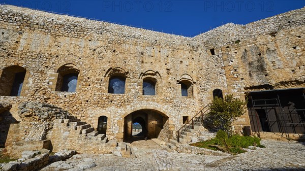 Inner courtyard of an old fortress with stone walls and arched windows, Chlemoutsi, High Medieval Crusader castle, Kyllini peninsula, Peloponnese, Greece, Europe