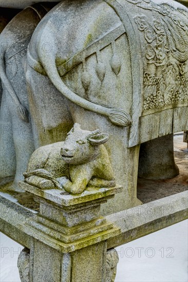 Stone carved ox, which represents the Chinese horoscope, on corner post of concrete fence in South Korea