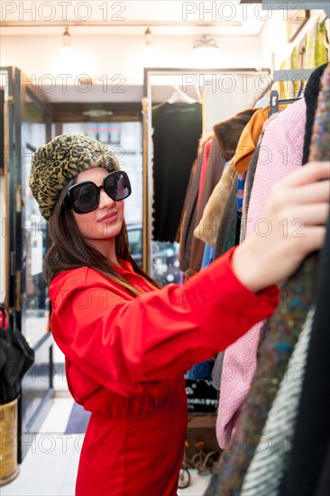 Vertical portrait of a beauty woman shopping in a second hand vintage store