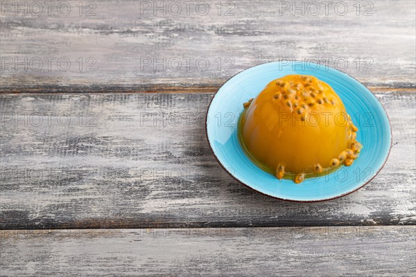 Mango and passion fruit jelly on gray wooden background. side view, copy space
