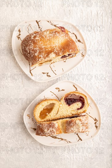 Homemade sweet bun with apricot jam on gray concrete background. top view, flat lay, close up