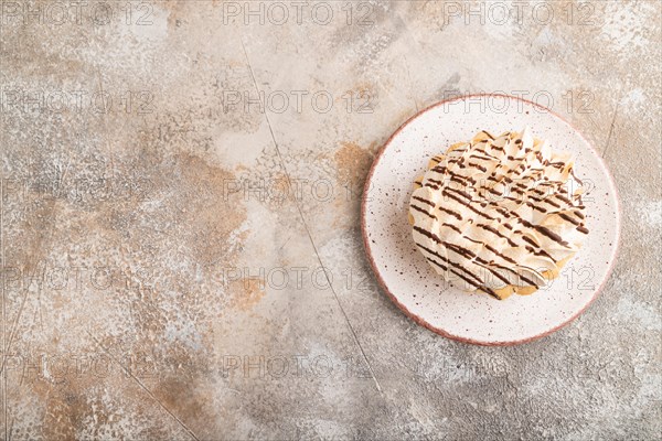 Tartlets with meringue cream on brown concrete background. top view, flat lay, copy space. Breakfast, morning, concept