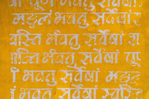Sanskrit mantra, white writing on yellow background, Tamil Nadu, India, Asia