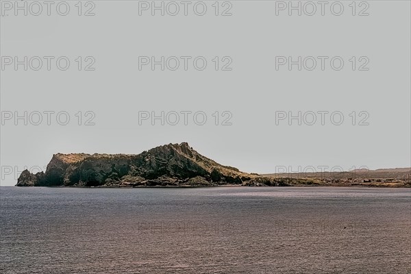 Volcanic mountain on tip of island with ocean in foreground