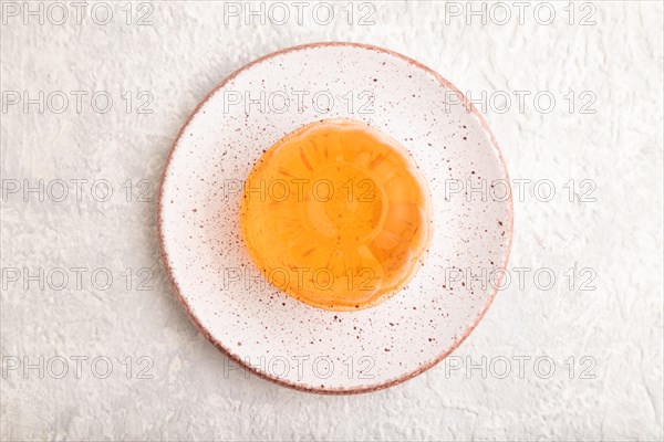 Papaya and orange jelly on gray concrete background. top view, flat lay, close up