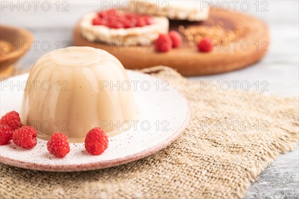 Buckwheat milk jelly on gray wooden background and linen textile. side view, close up, selective focus
