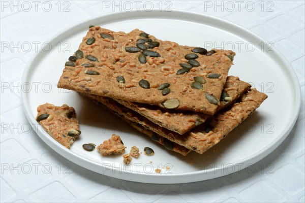 Crispbread with seeds on a plate, pumpkin seeds