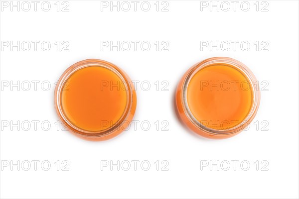 Baby puree with fruits mix, pumpkin, persimmon, mango infant formula in glass jar isolated on white background. Top view, flat lay, close up, artificial feeding concept