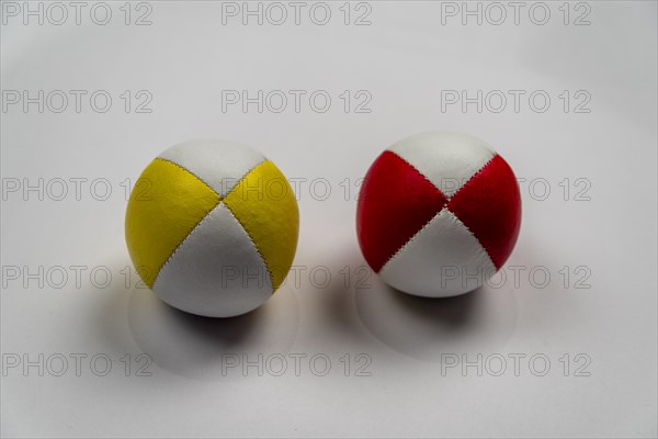 Two juggling balls in front of a white background, studio shot, Germany, Europe