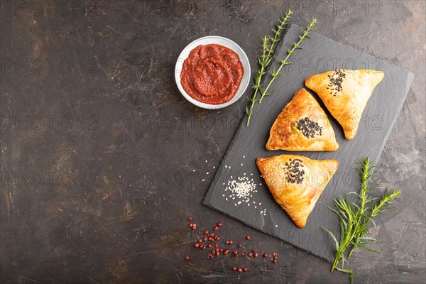 Homemade asian pastry samosa on black concrete background. top view, flat lay, copy space