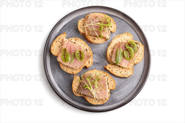 Bread sandwiches with jerky salted meat, sorrel and cilantro microgreen isolated on white background. top view, flat lay, close up