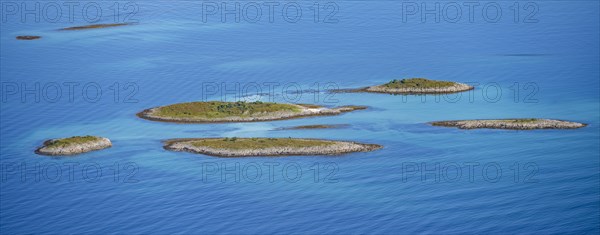 Rocky islands in the evening light, sea with archipelago islands, Ulvagsundet, Vesteralen, Norway, Europe