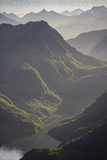 Fjord landscape with atmospheric evening light, Ulvagfjorden fjord and mountains, view from the top of Dronningsvarden or Stortinden, Vesteralen, Norway, Europe