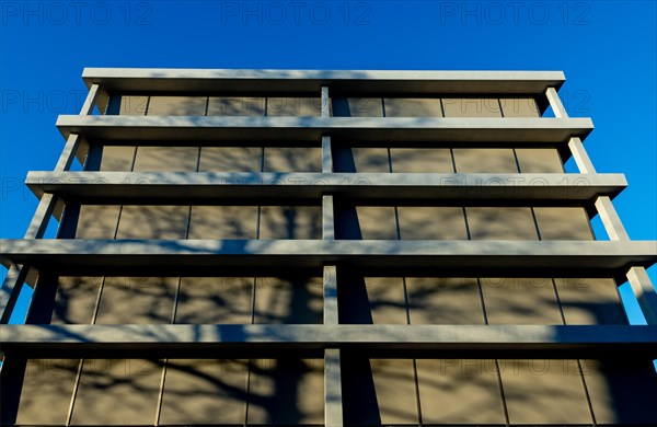 Modern Design of a Building with Tree Shadow and Blue Clear Sky in a Sunny Day in Switzerland