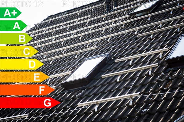 Mounted brackets for solar panels on the roof of a house, graphic with energy efficiency classes for buildings according to the GEG, Duesseldorf, Germany, energy efficiency, Europe
