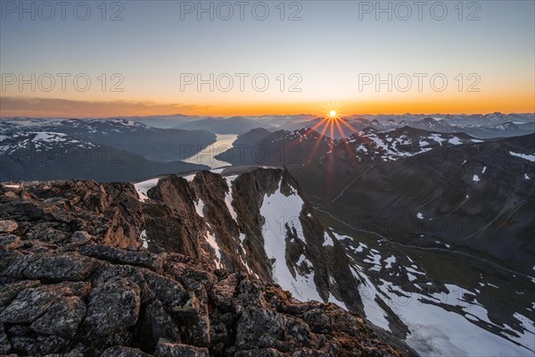 View of mountains and fjord Faleidfjorden, sun star at sunset, summit of Skala, Loen, Norway, Europe