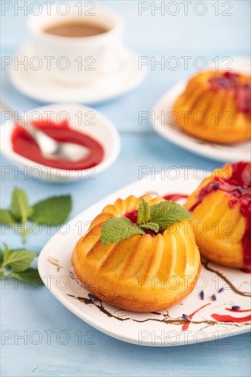 Semolina cheesecake with strawberry jam, lavender, cup of coffee on blue wooden background. side view, close up, selective focus