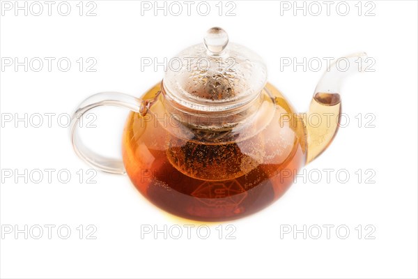 Red tea with herbs in glass teapot isolated on white background. Healthy drink concept. Side view, close up