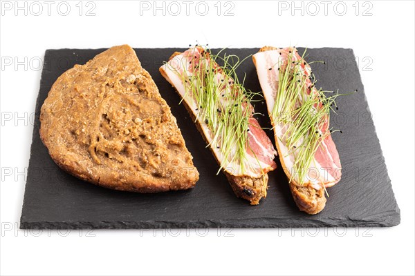 Bread sandwiches with jerky salted meat and lard with onion microgreen isolated on white background. side view, close up