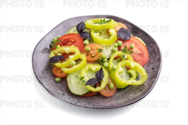 Vegetarian salad from green pea, tomatoes, pepper and basil isolated on white background. Side view, close up
