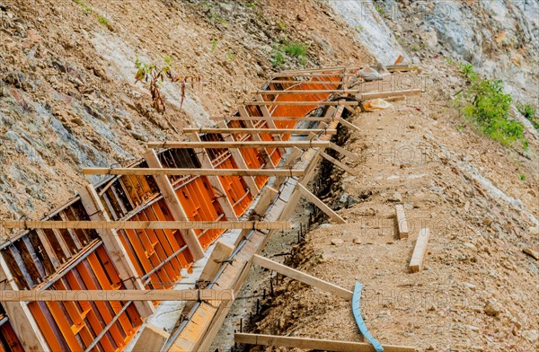 Construction form for man made drainage ditch on side of mountain