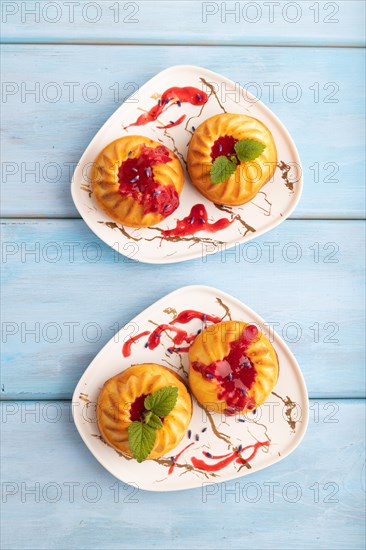 Semolina cheesecake with strawberry jam, lavender, on blue wooden background. top view, flat lay, close up