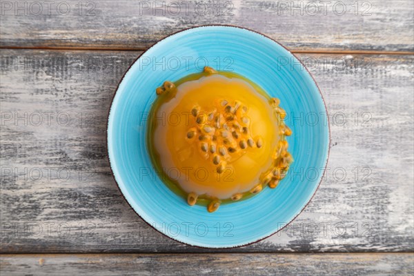 Mango and passion fruit jelly on gray wooden background. top view, flat lay, close up