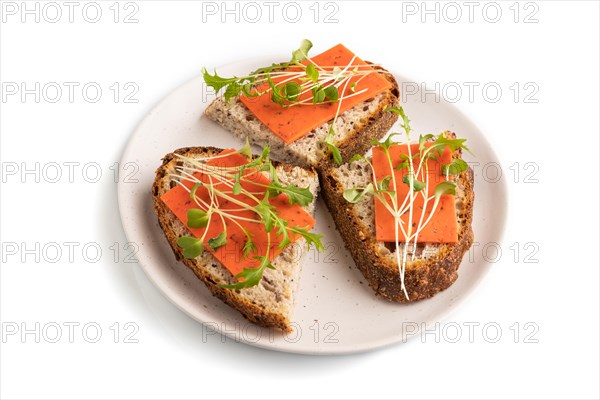 Grain bread sandwiches with red tomato cheese and mizuna cabbage microgreen isolated on white background. side view, close up