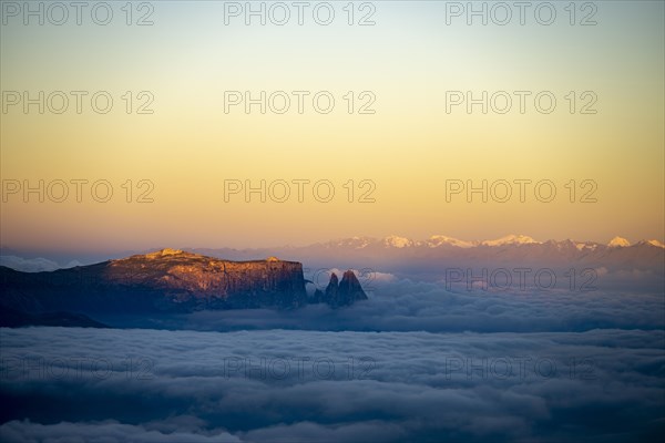 Sunrise over a sea of fog with the peaks of the Sella massif in the background, Corvara, Dolomites, Italy, Europe