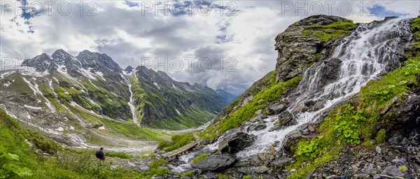 Panorama, green mountain valley Floitengrund with mountain stream Floitenbach, mountaineer on a hiking trail, waterfall on a mountain slope, ascent to Greizer Huette, Berliner Hoehenweg, Zillertal Alps, Tyrol, Austria, Europe