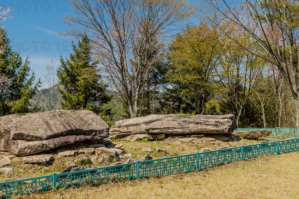Ancient boulders in fenced rock garden in wilderness mountain park in South Korea