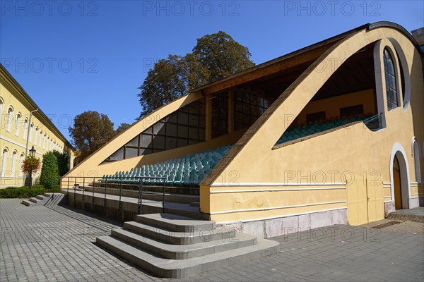 A modern yellow open-air grandstand with many steps on a sunny day, church, officers' palace, Komarno, Komarom, Komorn, Nitriansky kraj, Slovakia, Europe