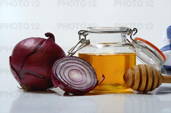 Honey in a jar and red onion, ingredients for cough syrup