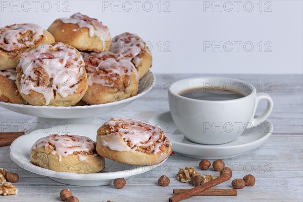 Appetising breakfast arrangement with cinnamon buns and coffee on a wooden table