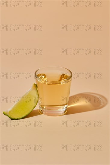 View from above on tequila shot with slice of lime