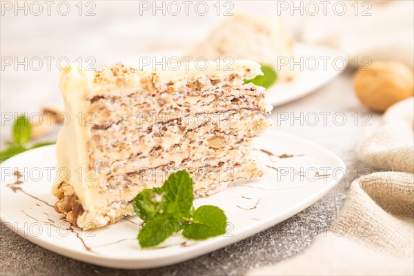 Walnut and almond cake on brown concrete background and linen textile. side view, close up, selective focus