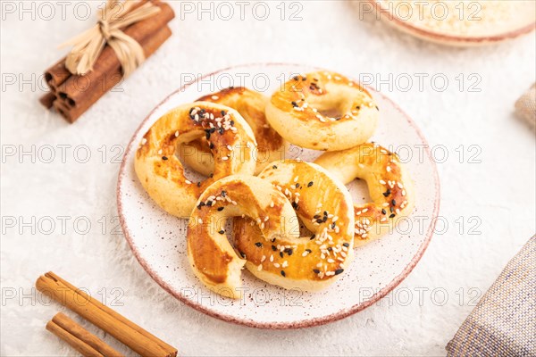 Homemade asian salted cookies, cup of green tea on gray concrete background and linen textile. side view, selective focus