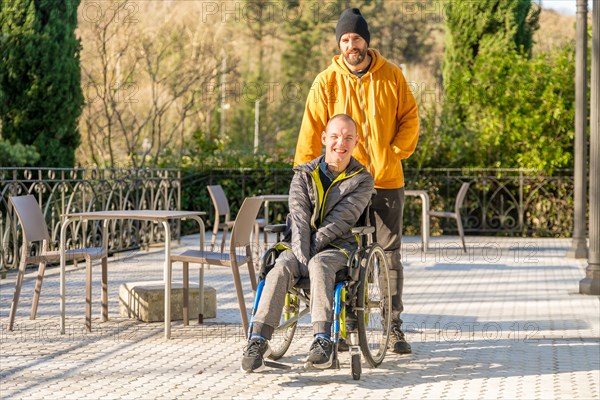 Portrait with copy space of a happy disabled man and friends in a sunny urban park